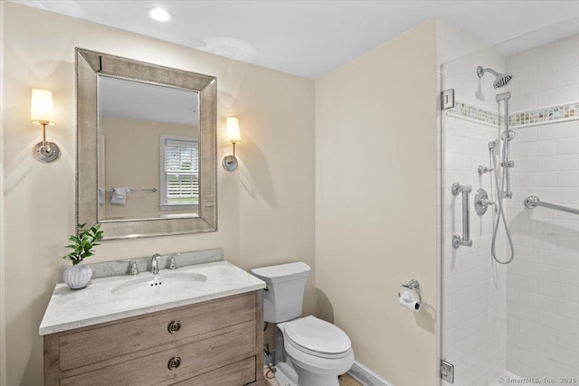 bathroom featuring toilet, vanity, and walk in shower