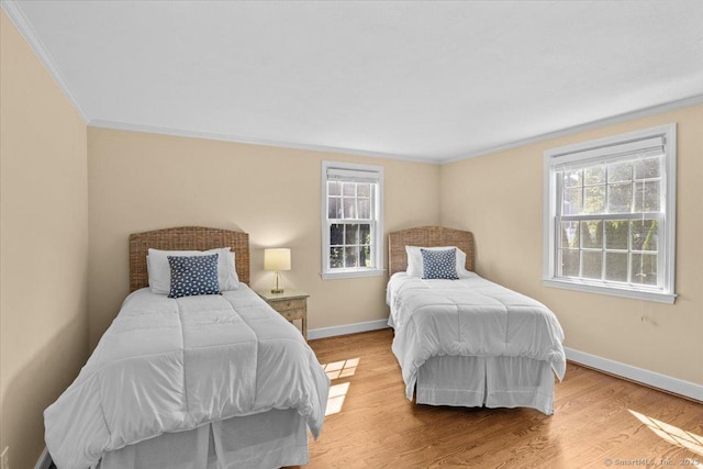 bedroom with light hardwood / wood-style floors and crown molding