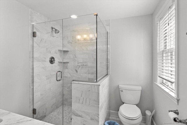 bathroom with walk in shower and toilet