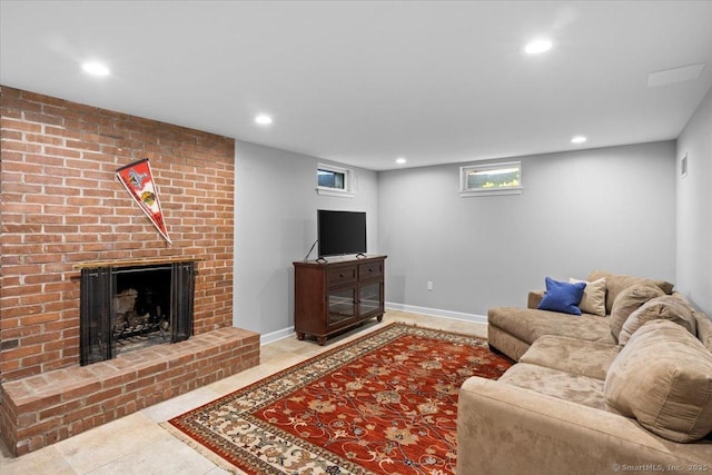 living room with a fireplace and light tile patterned flooring