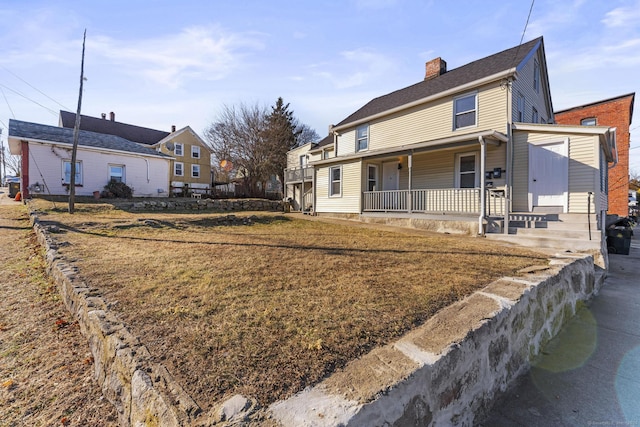 exterior space featuring a lawn and a porch