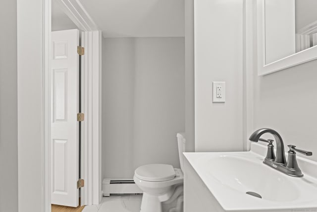 bathroom with a baseboard radiator, toilet, and sink