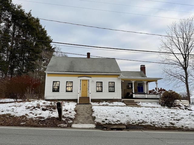 cape cod house featuring a porch