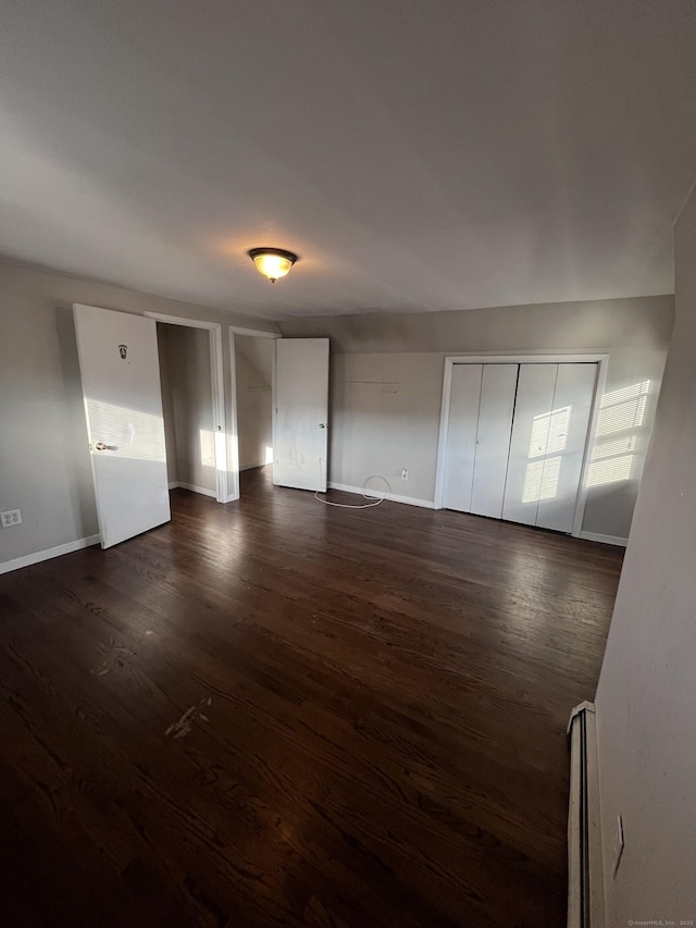 interior space with dark wood-type flooring and a baseboard radiator