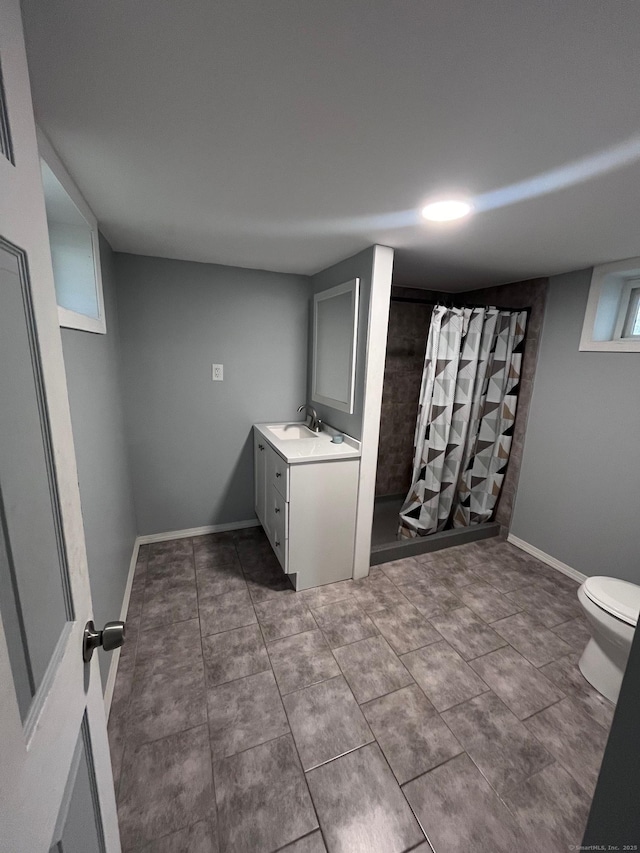 bathroom featuring toilet, walk in shower, and vanity