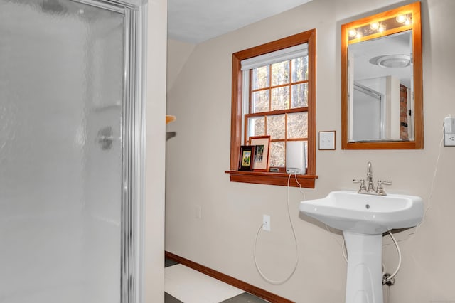 bathroom with walk in shower and sink