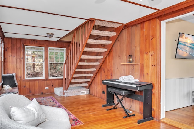 living room featuring wood-type flooring and wooden walls