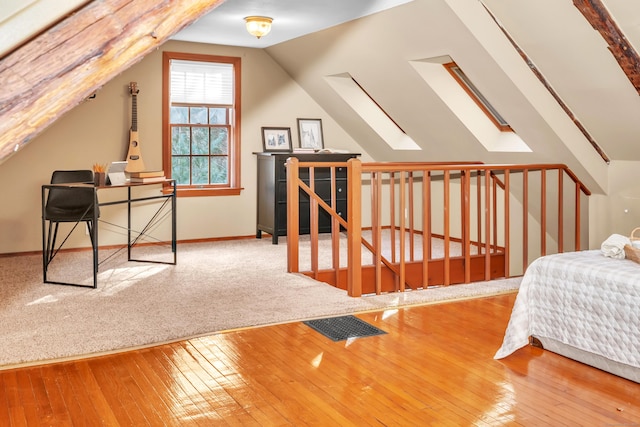 bedroom featuring wood-type flooring and lofted ceiling with skylight