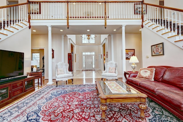 living room featuring a high ceiling and decorative columns