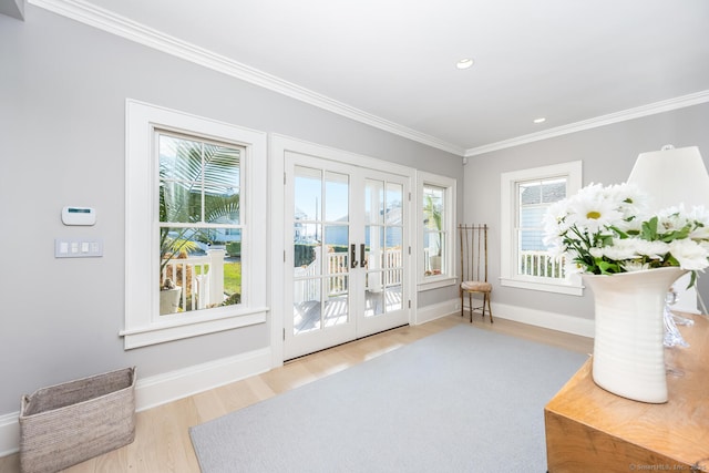 sitting room with wood finished floors, baseboards, recessed lighting, french doors, and crown molding