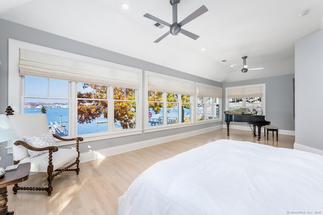 bedroom featuring visible vents, baseboards, a water view, recessed lighting, and wood finished floors