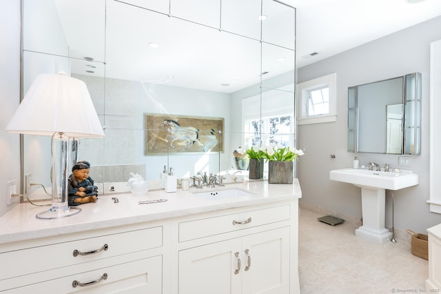 full bathroom with tile patterned flooring, baseboards, and a sink