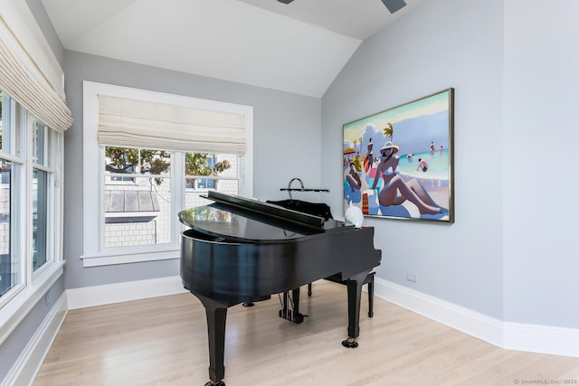 sitting room featuring baseboards, lofted ceiling, and light wood finished floors