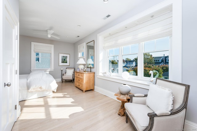 bedroom featuring visible vents, baseboards, and wood finished floors