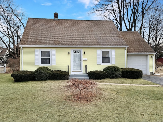 view of front of house featuring a garage and a front lawn