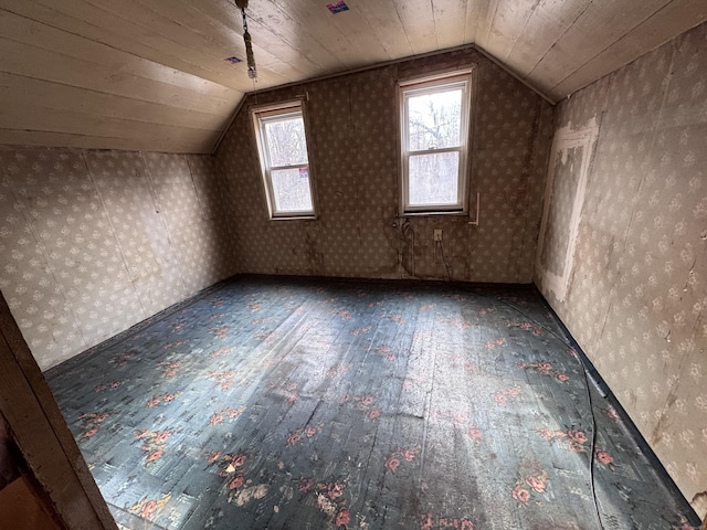 additional living space with lofted ceiling, wood-type flooring, and wooden ceiling