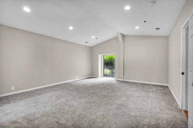 carpeted spare room featuring lofted ceiling