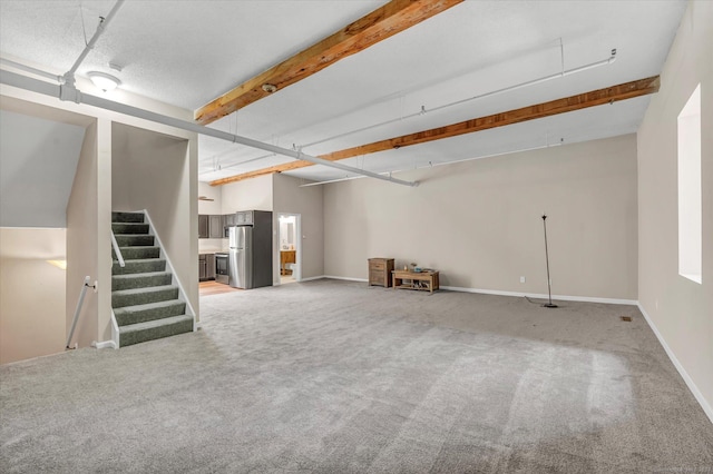 basement with stainless steel refrigerator and carpet