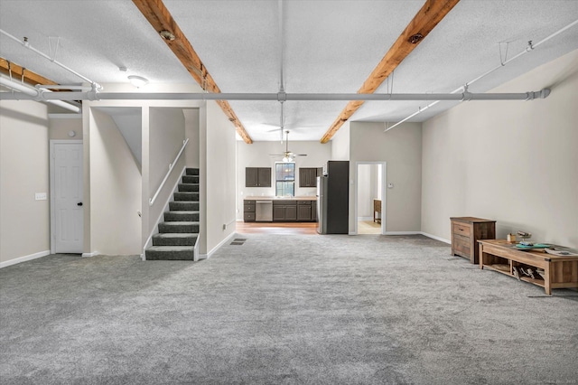 basement featuring a textured ceiling, stainless steel fridge, and carpet floors