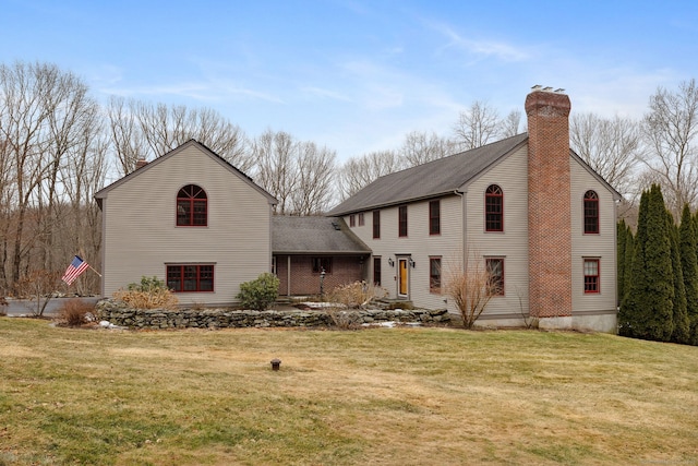 view of front facade with a front lawn and a chimney