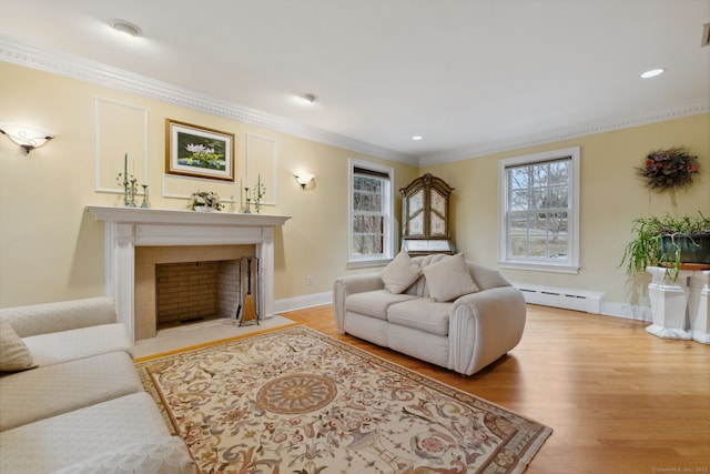 living area with a baseboard heating unit, plenty of natural light, ornamental molding, and light wood finished floors