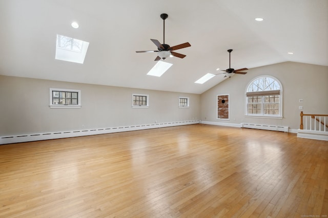 interior space featuring light wood-type flooring, a baseboard radiator, lofted ceiling, and baseboards