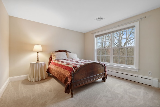 bedroom with baseboards, visible vents, baseboard heating, and carpet floors