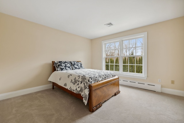 carpeted bedroom with visible vents, baseboards, and a baseboard radiator