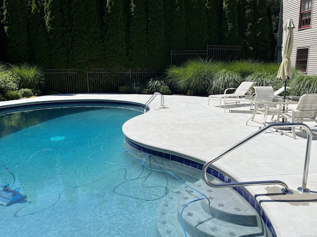 view of swimming pool with a fenced in pool, a patio, and fence