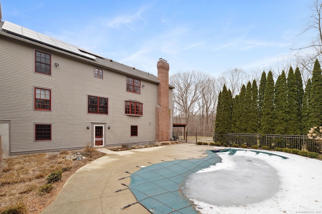 view of swimming pool with a fenced in pool, fence, and a patio area