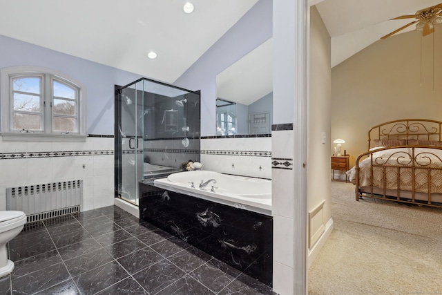 bathroom with radiator, a garden tub, vaulted ceiling, a stall shower, and tile walls