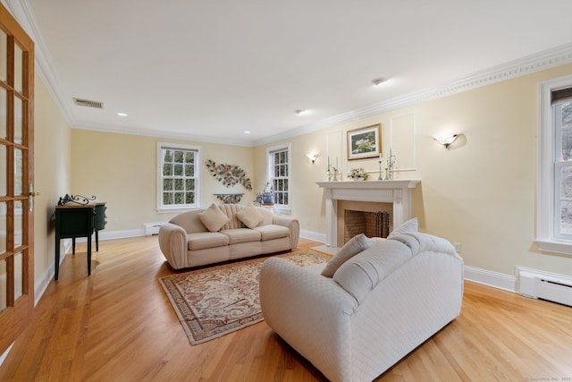 living room featuring light wood finished floors, visible vents, a fireplace, and baseboards