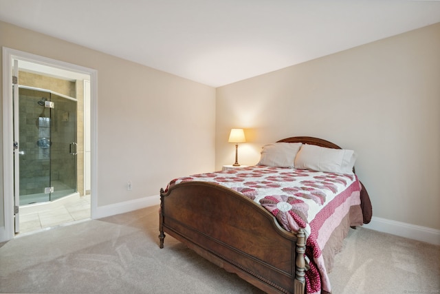 carpeted bedroom featuring connected bathroom and baseboards