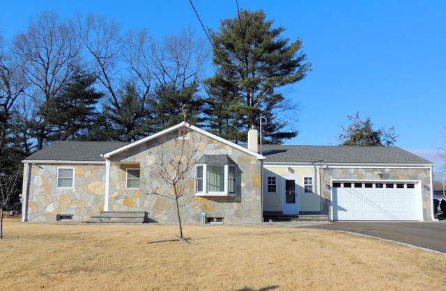 single story home featuring a garage and a front yard