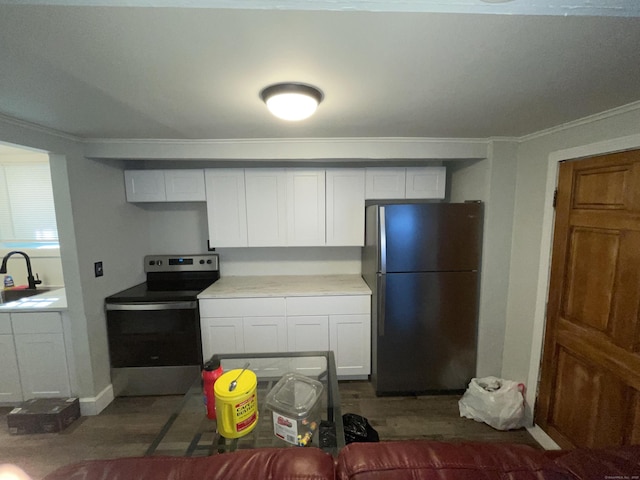 kitchen featuring stainless steel appliances, crown molding, white cabinets, and sink