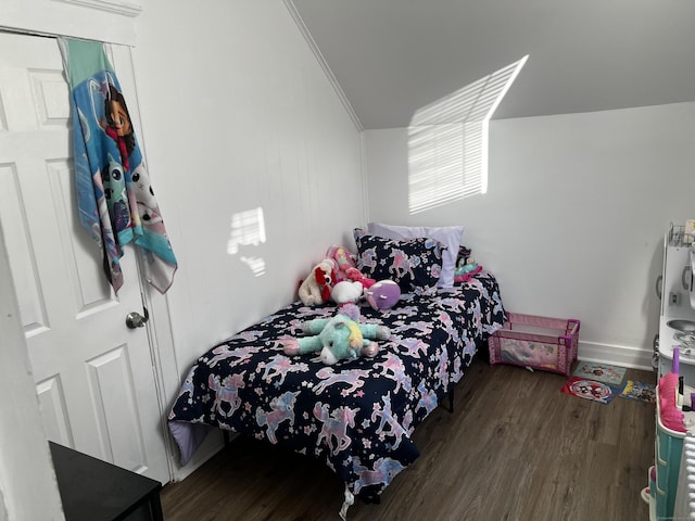 bedroom with vaulted ceiling, crown molding, and dark hardwood / wood-style floors