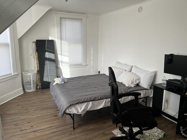 bedroom featuring dark hardwood / wood-style floors and ornamental molding