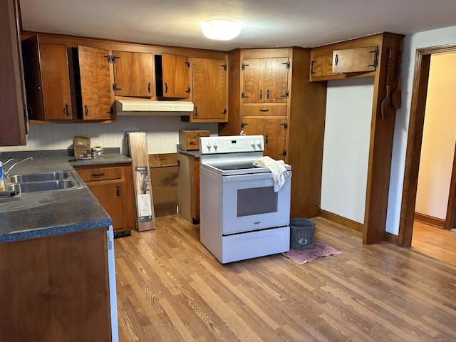 kitchen featuring sink, white range with electric stovetop, and light hardwood / wood-style floors