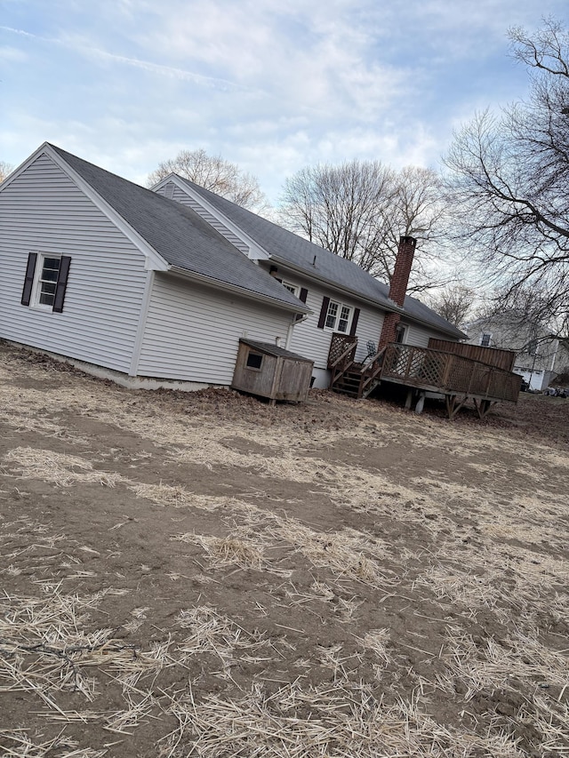 rear view of property featuring a deck