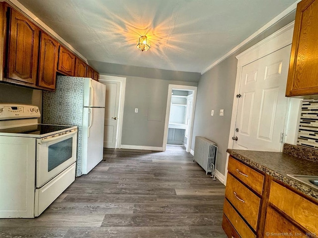 kitchen with white appliances, crown molding, radiator, dark hardwood / wood-style flooring, and decorative backsplash