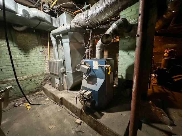 utility room featuring heating unit