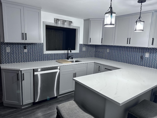 kitchen with gray cabinets, tasteful backsplash, decorative light fixtures, a kitchen breakfast bar, and dishwasher