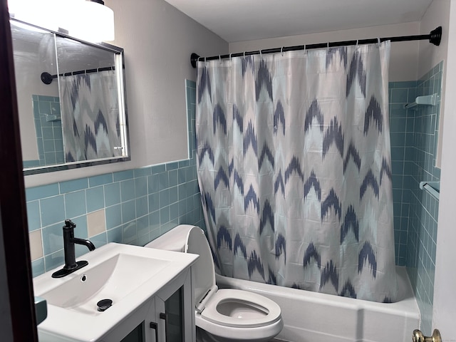 full bathroom with toilet, vanity, tile walls, and shower / bath combo