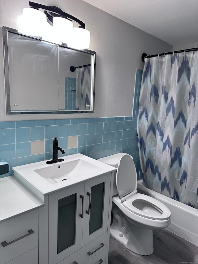 full bathroom featuring tile walls, toilet, vanity, and shower / bathtub combination with curtain