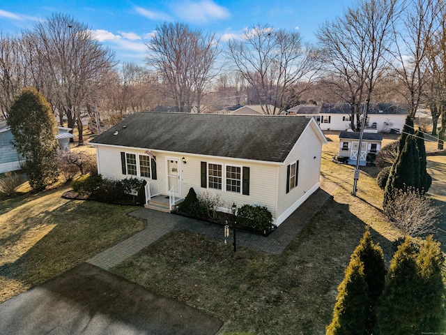 ranch-style home with a front lawn