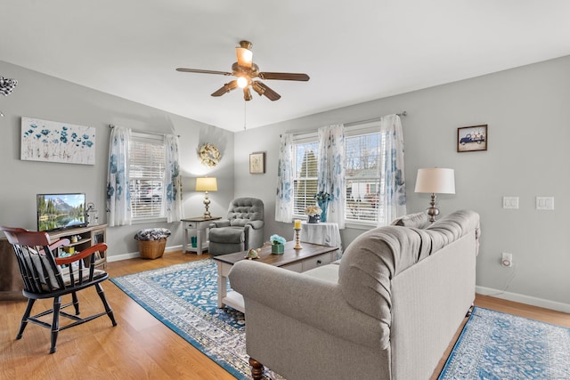 living room featuring ceiling fan and wood-type flooring