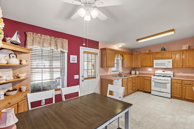 kitchen with ceiling fan, sink, and white appliances