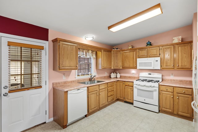 kitchen featuring sink, white appliances, and vaulted ceiling