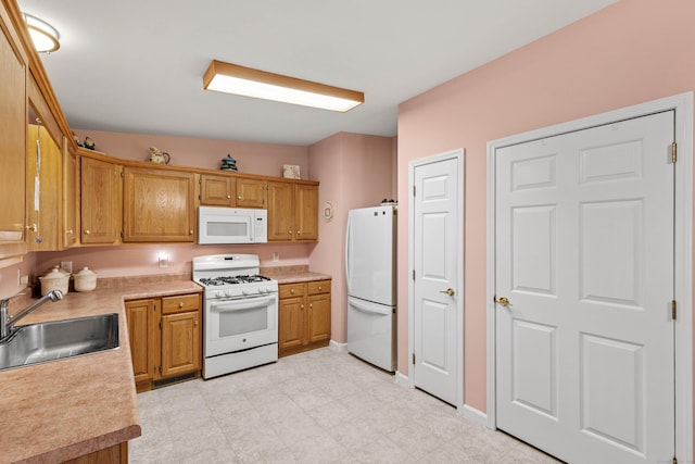 kitchen with sink and white appliances