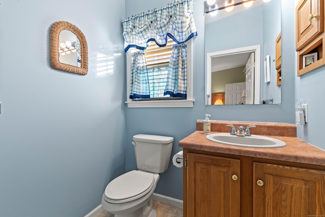 bathroom with toilet and vanity